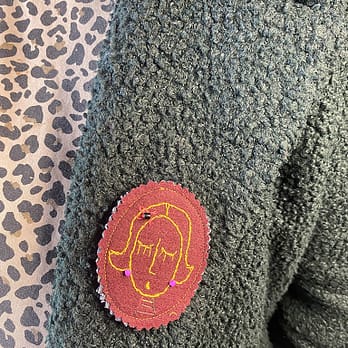 Broche ovale Tata Ariane jaune portée